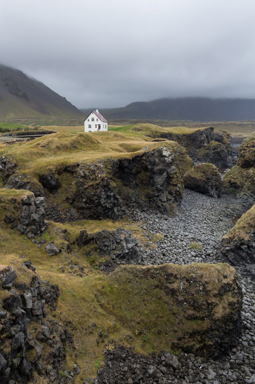 Lone white house on a cliff in Arnarstapi, Iceland