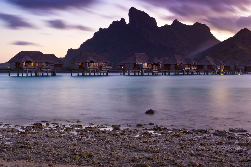 Purple sunset behind Mount Otemanu and overwater bungalows