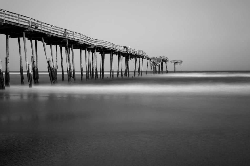 Black-and-white long exposure shot of the decrepit Frisco Pier collapsing