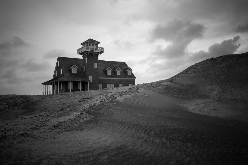 Oregon Inlet Life-saving Station behind a sand dune of the Pea Island National Wildlife Refuge